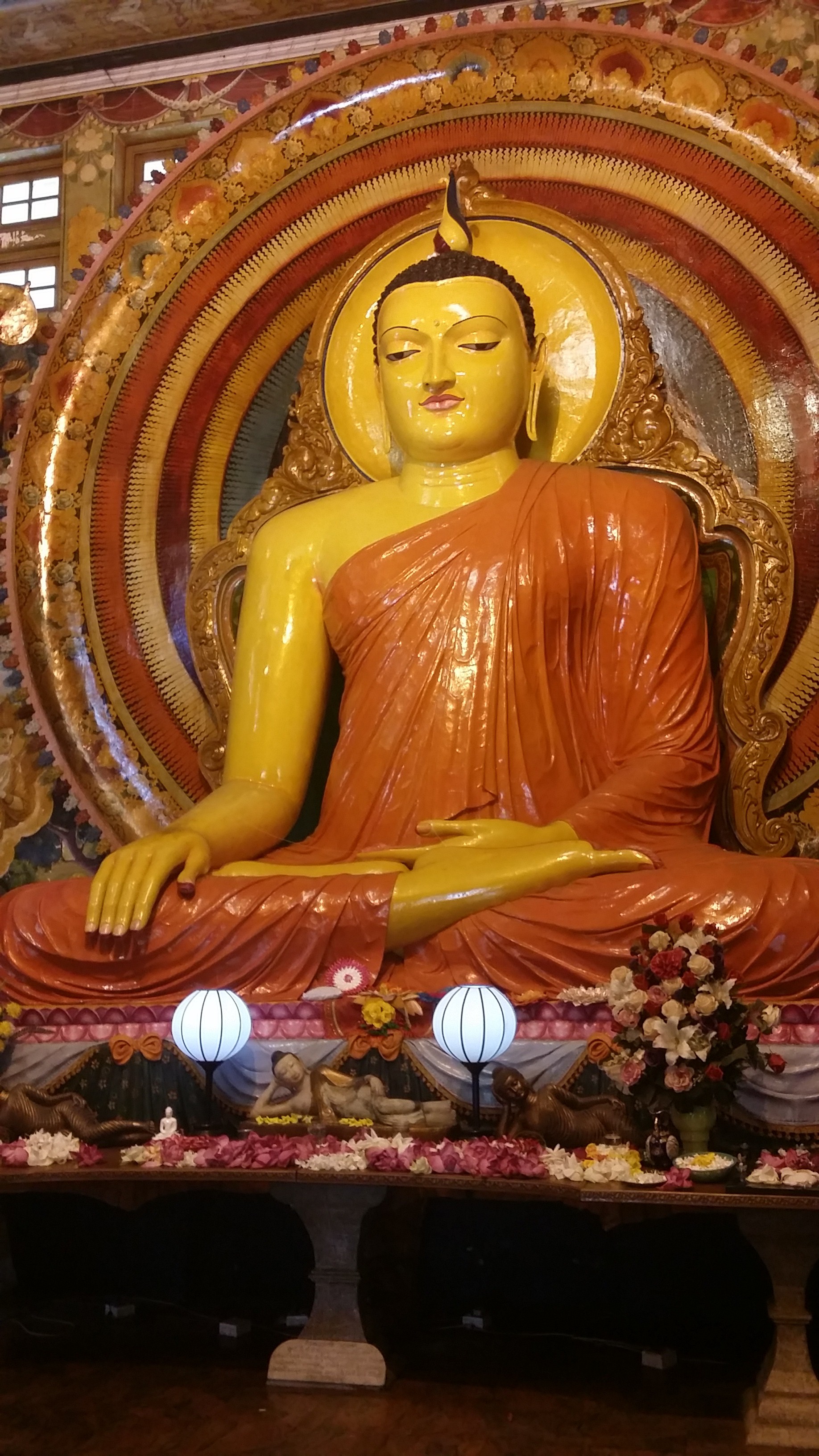 Image: Gangaramaya Temple Haven't blogged in a while, but since we're in India now and I can't get off, I have some time! This cruise started off with a day in Phuket, Thailand! Went out with some friends and got lunch. Green curry chicken and rice! Then we went on an adventure at got mopeds. I attempted to drive one, with not so much success, so I ended up riding with a friend. We drove to a waterfall. Not a big one, but pretty! We climes up a bit and got some great pics. Afterwards we headed back to the ship. Our next stop was Colombo, Sri Lanka. A few of us were going to go to the tea plantation, but when we found out it was a 2hr taxi ride away we decided it wasn't worth it. I ended up going out with Diana. We found a Tuk Tuk, which is basically a moped with a car built around it so people can sit in the back, and he took us around to a few of the temples. They're gorgeous! The intricate decor and the Buddhas were very moving and wonderful to see. One of the temples we visited was built around a giant tree that they believe to have healing powers. In the temple you're required to remove your shoes, and cover your knees, they have skirts at the door for those with shorter shorts. We ended our day by getting food at the mall. We both went with more local food...though there was a Pizza Hut and a Dominoes in the food court! Lunch cost us each about $4. We also went to the supermarket in the mall and picked up some snacks for this week. I found Mt. Dew! That made me super happy, I didn't think I was going to be able to have that till I got home. So now that I've been fully doing my job for over a week I figured I should explain exactly what I do. The Production Manager A is in charge of everything that happens in the theatre. I am in charge of everything that happens in the lounges. My day starts with me checking emails, then I take a walk around the ship to make sure everything is struck from the previous night. Throughout the day I continue to walk around the lounges and make sure set ups are happening when they're supposed to. I also spend about an hour and a half a day making the schedule for the next day. Sometimes I do spots for the shows in the theatre at night if we don't have enough people. I end my day in Reflections, the largest lounge, with whatever main event is happening that night. I have another post almost ready to go, but I will wait to post it! Love to all!