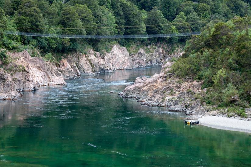 A bridge connects the tree-lined cliffs of New Zealand's Buller Gorge. (Photo:   Philip Bird LRPS CPAGB  /Shutterstock)