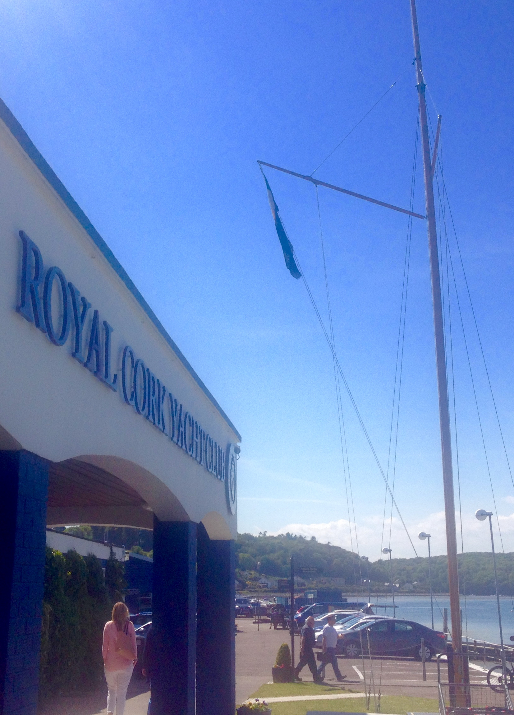 From the mast hangs the civil ensign club members can legally use on their boats: the Irish flag in canton on a field of blue, defaced with a crowned golden harp.