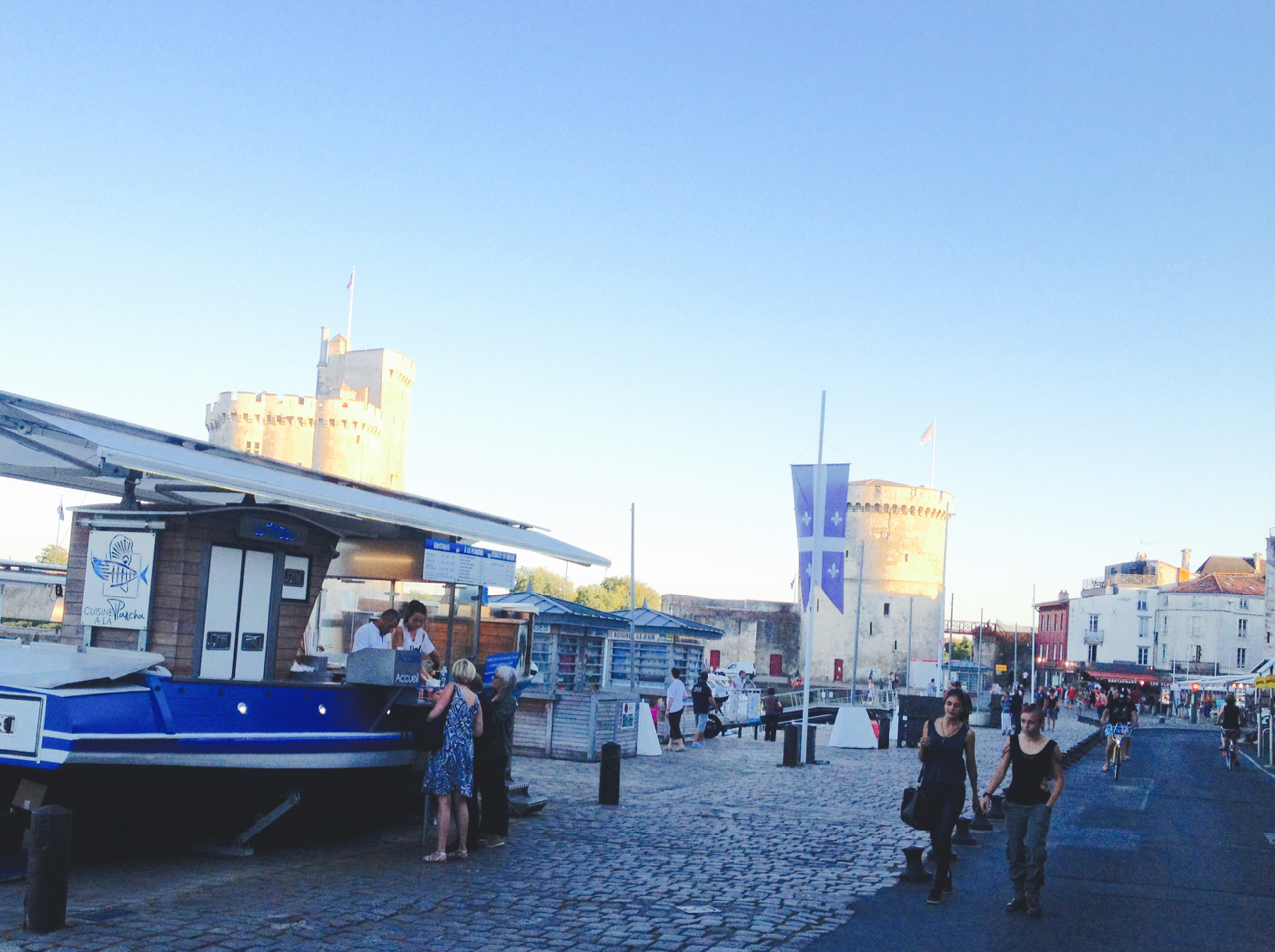 The La Rochelle waterfront from inside the walls. A La Plancha is a full restaurant ingeniously built on a small fishing boat. iPhone 4S, 9:20 pm, 29 June 2015.