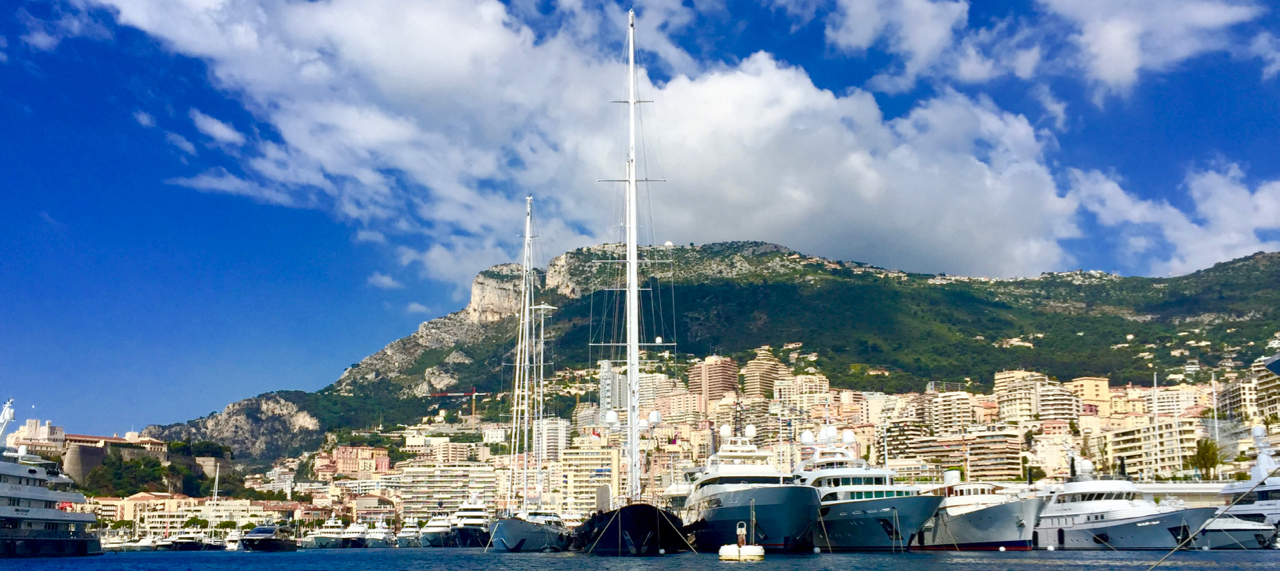 Port Hercole from P eregrinus ' Zodiac tender. On the very left, the Rock of Monaco, with the princely palace and Monaco-Ville. Behind the boats, La Condamine and above the built-up-area, the Tête de Chien mountain. 14 June 2016, iPhone 6 Plus.