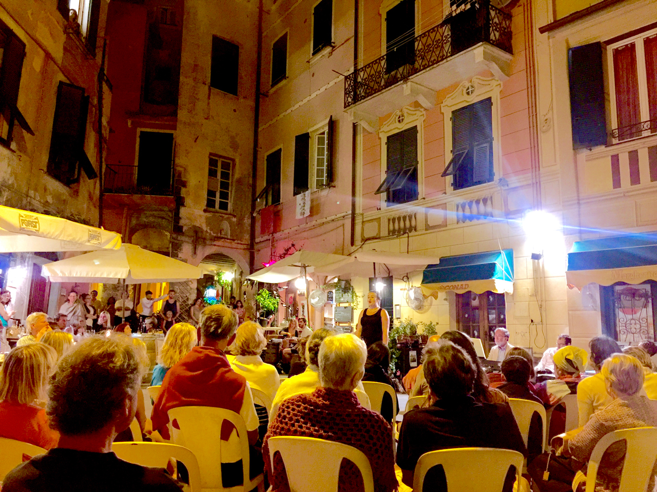In Monterosso al Mare, when the fat lady sings, the aria concert right in the middle of the street is only getting started. Peregrinus laid on a park buoy just in front of town. 10:16 pm, 16 July 2016, iPhone 6 Plus.