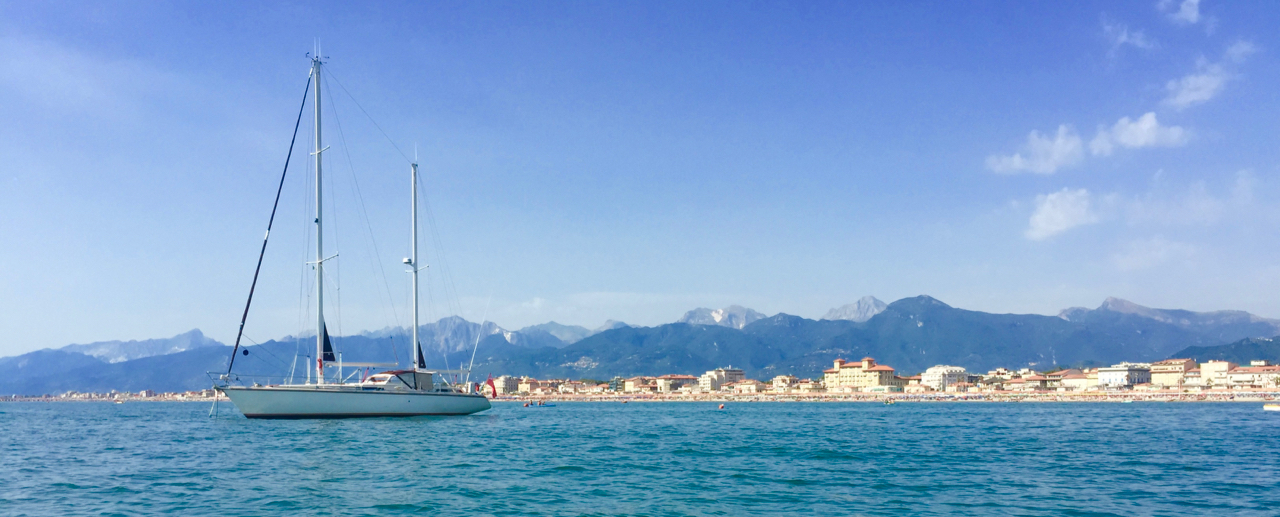 Peregrinus anchored in the roadstead at the entrance to the Viareggio harbour, shipyards, and canals. 22 July, iPhone 6 Plus.