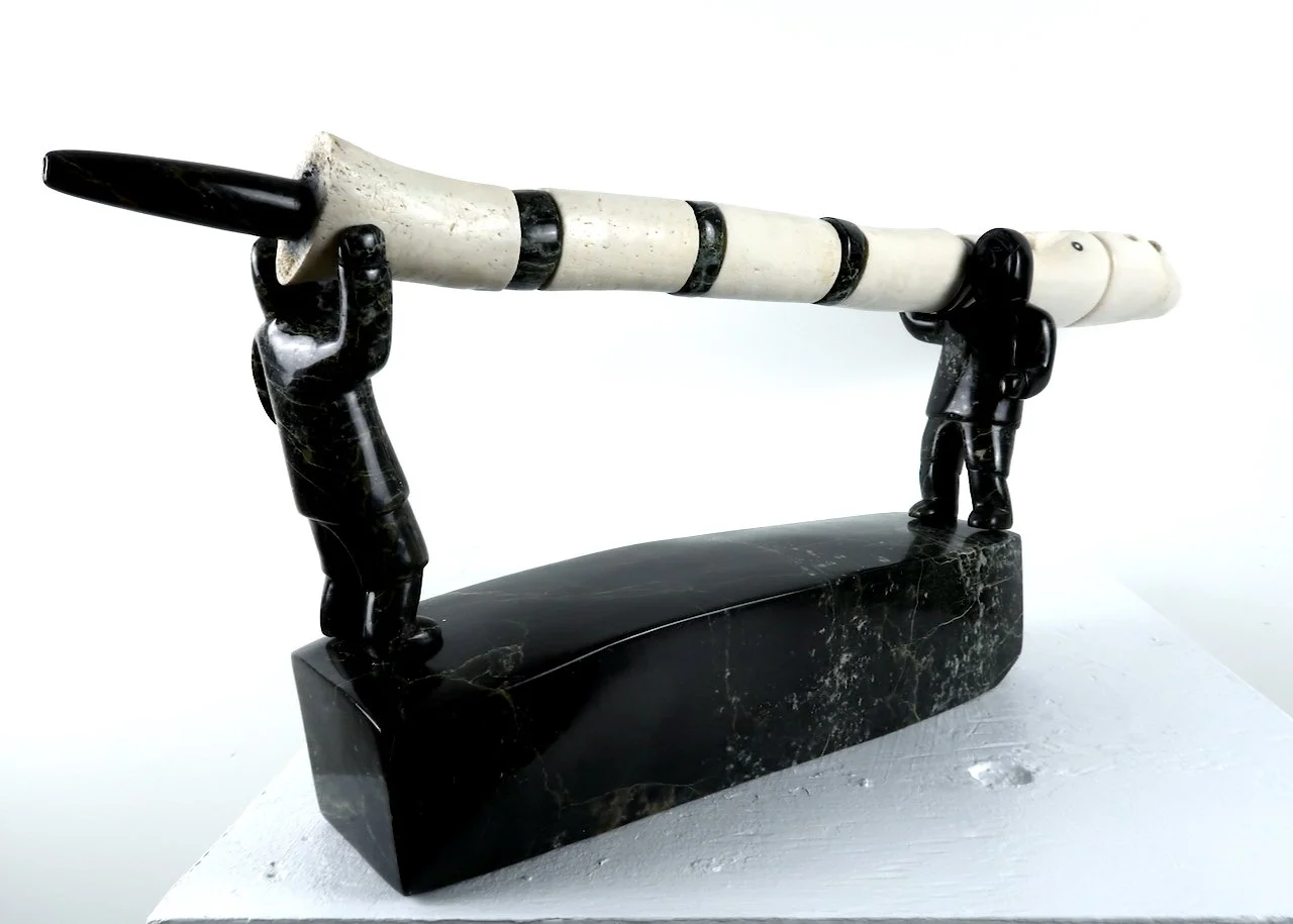  Pitseolak Qimirpik Two Men Carrying Pipe	 24 x 8.5 x 3.5	 Serpentine, Bone $ 3750 