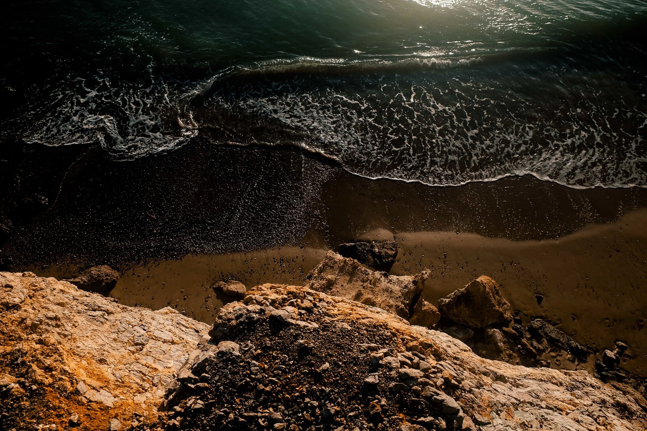 Waves washing up against the dunes on the beach.