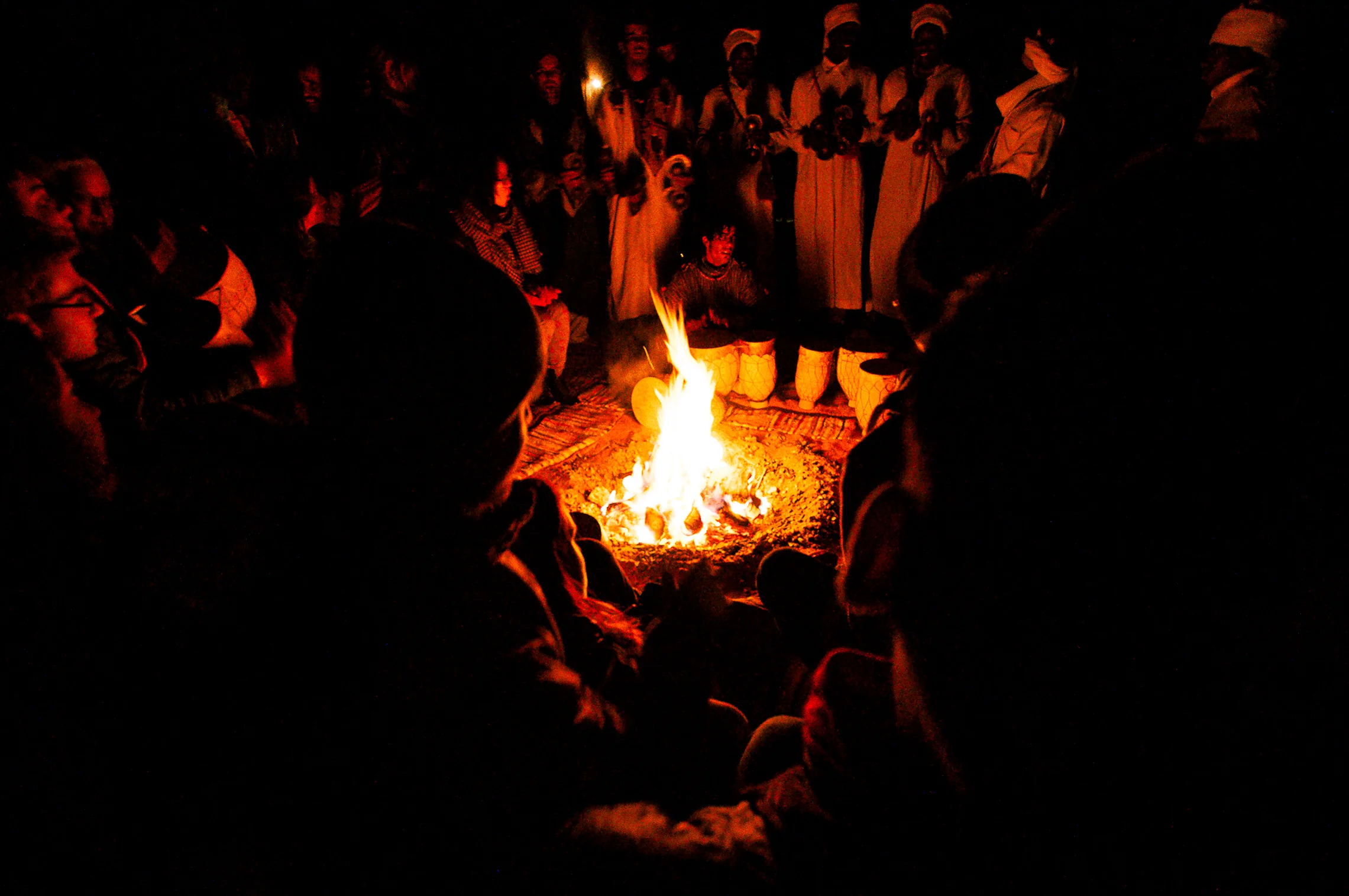 Everybody gathered around the bonfire in the middle of camp.