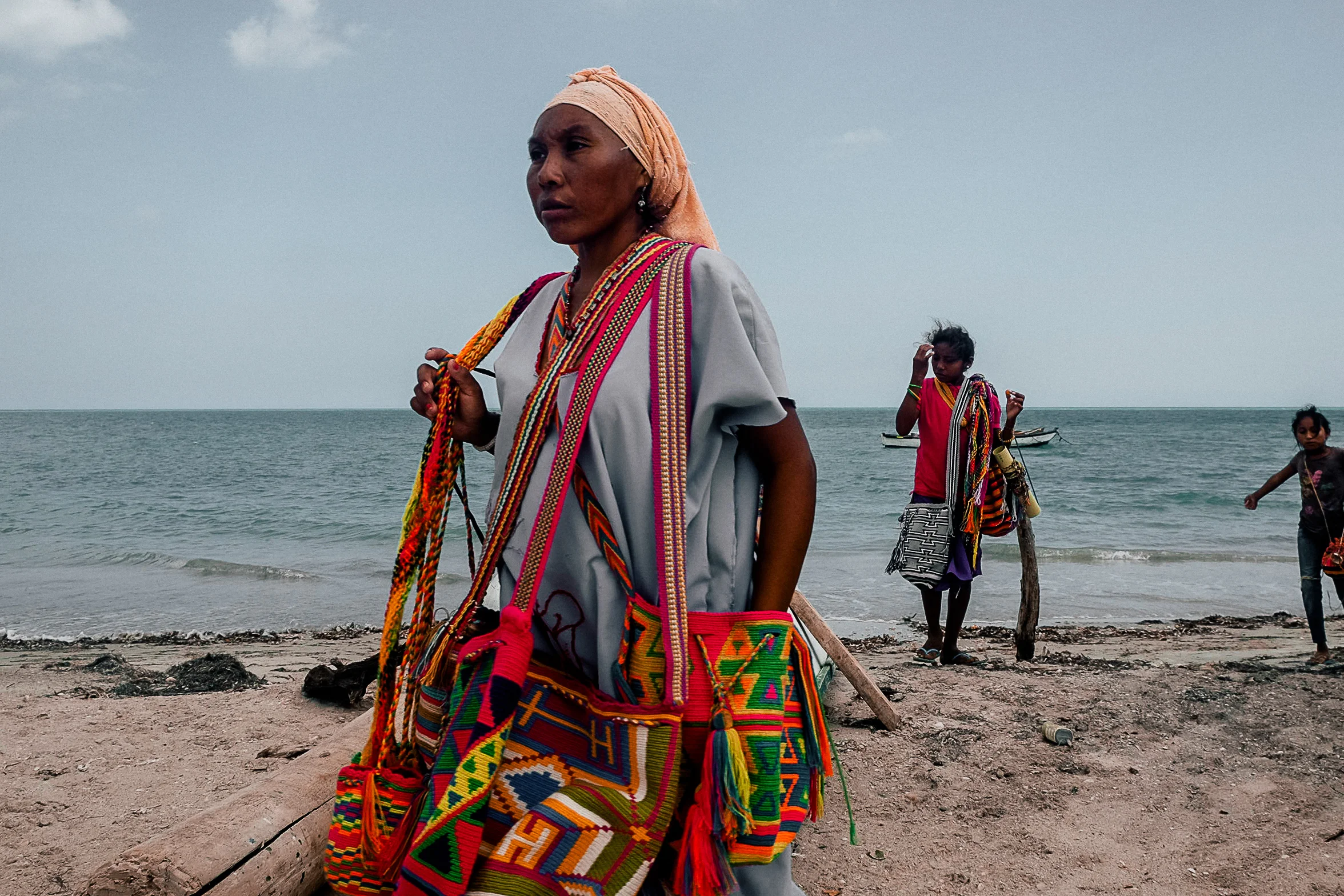 Merchants selling handmade patterned bags on the coast in Riohacha.