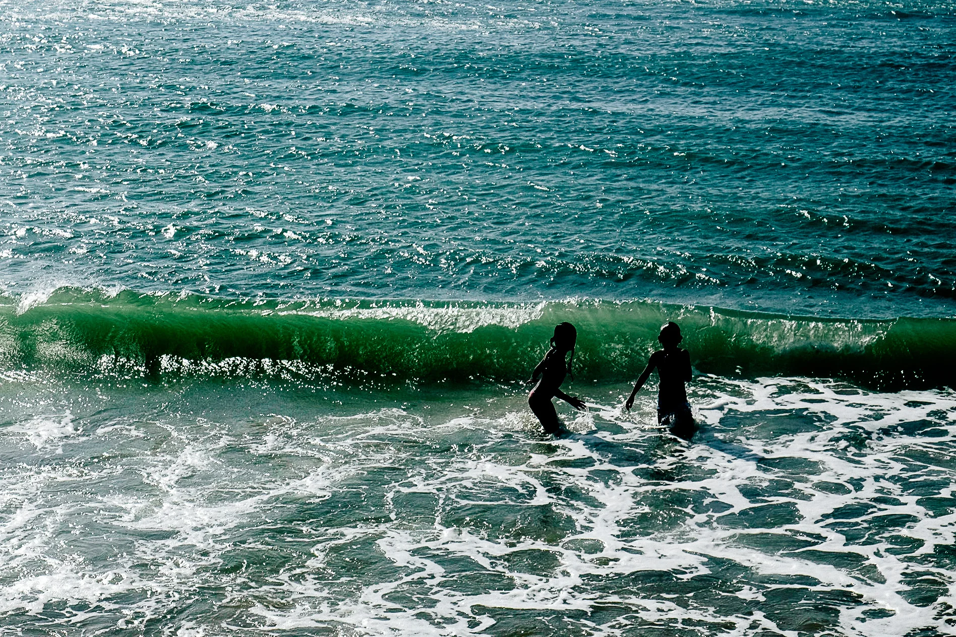 Kids jumping waves.