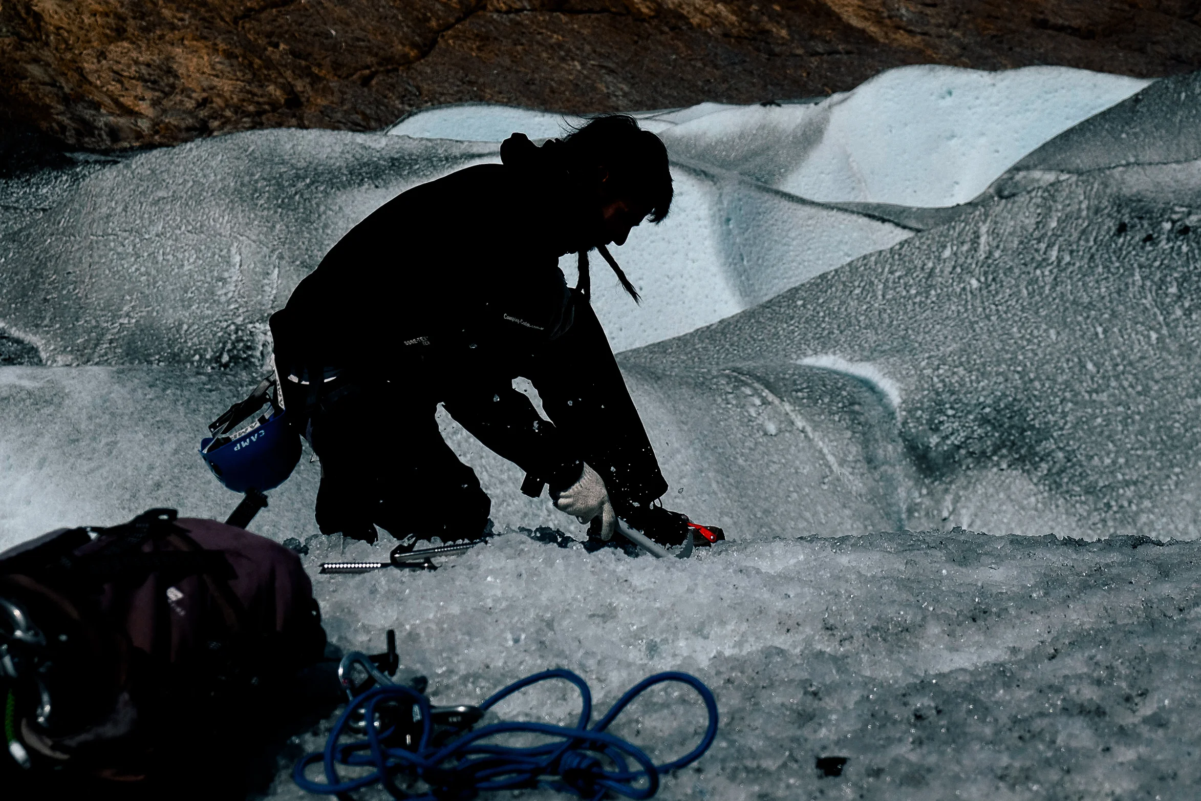 Drilling the cable stays into the ice to set up the anchors for the rope.