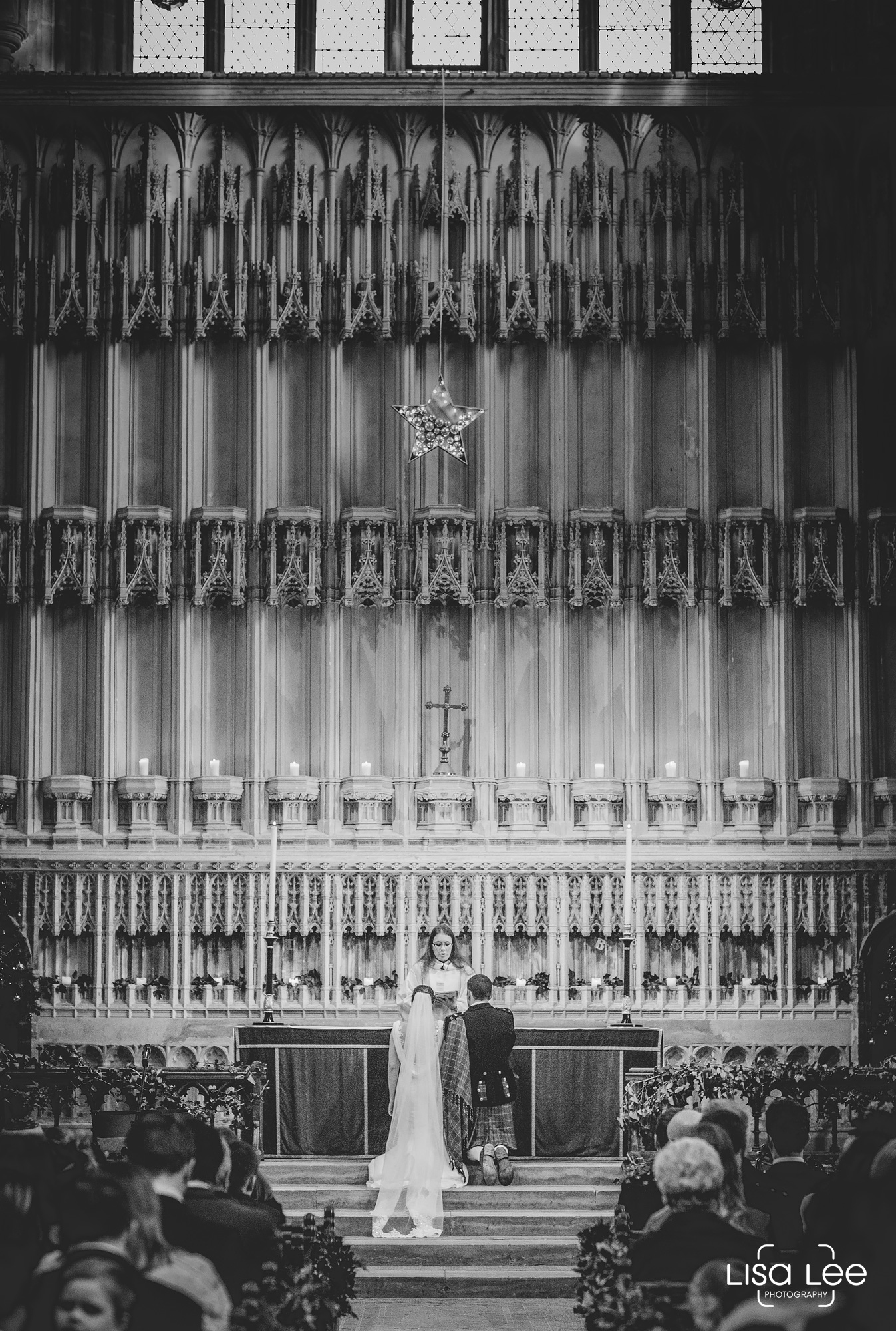 wedding-photography-milton-abbey-ceremony-kneeling.jpg