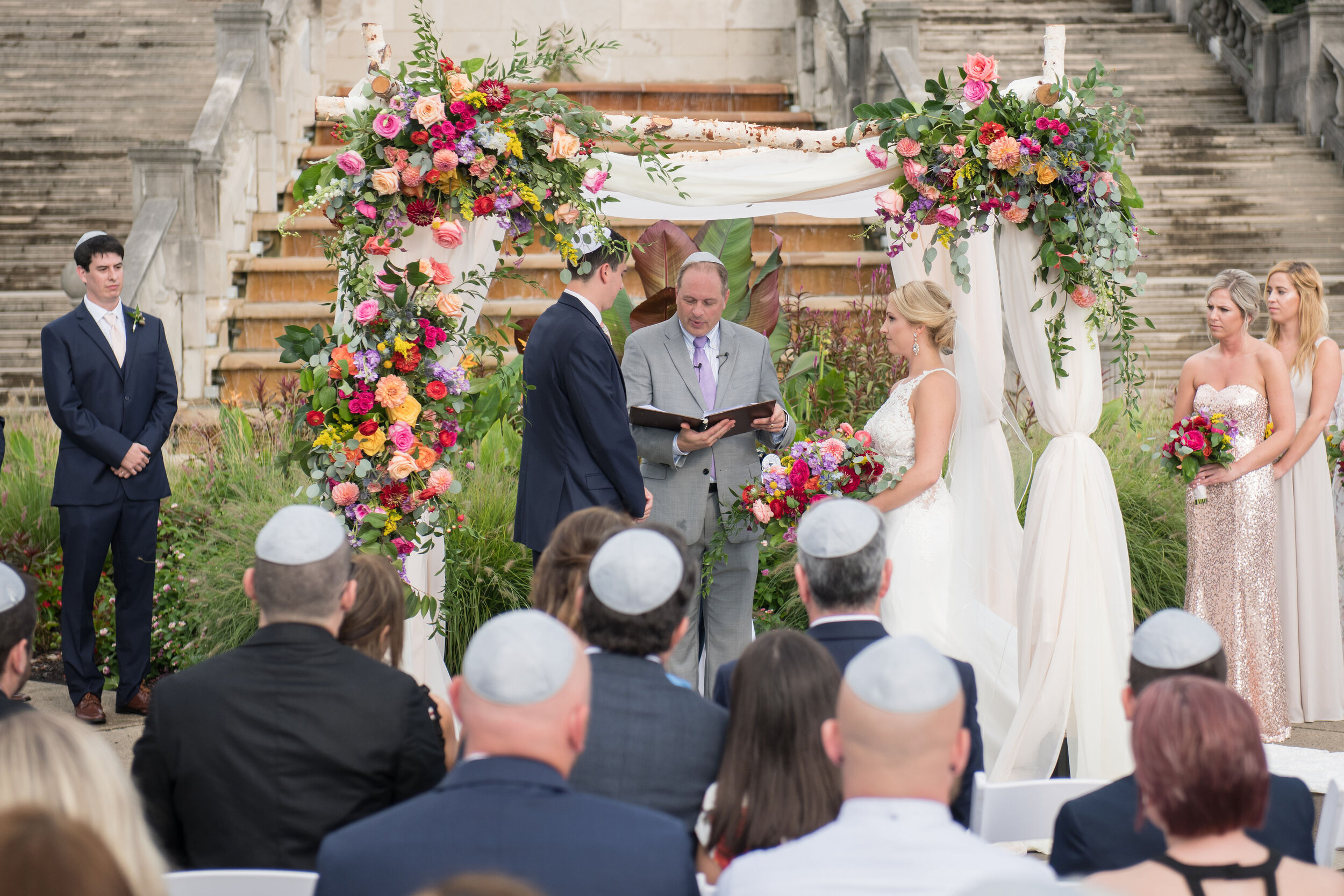 Chuppah with Colorful Florals and White Drapery