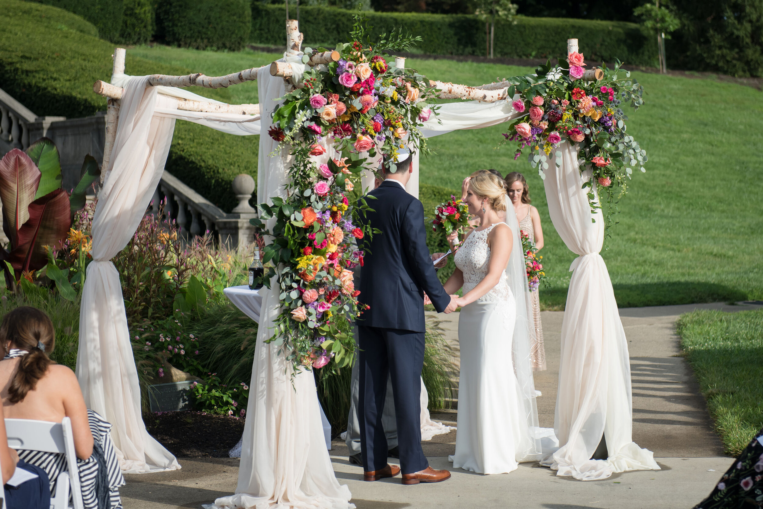 Chuppah with Colorful Florals and White Drapery