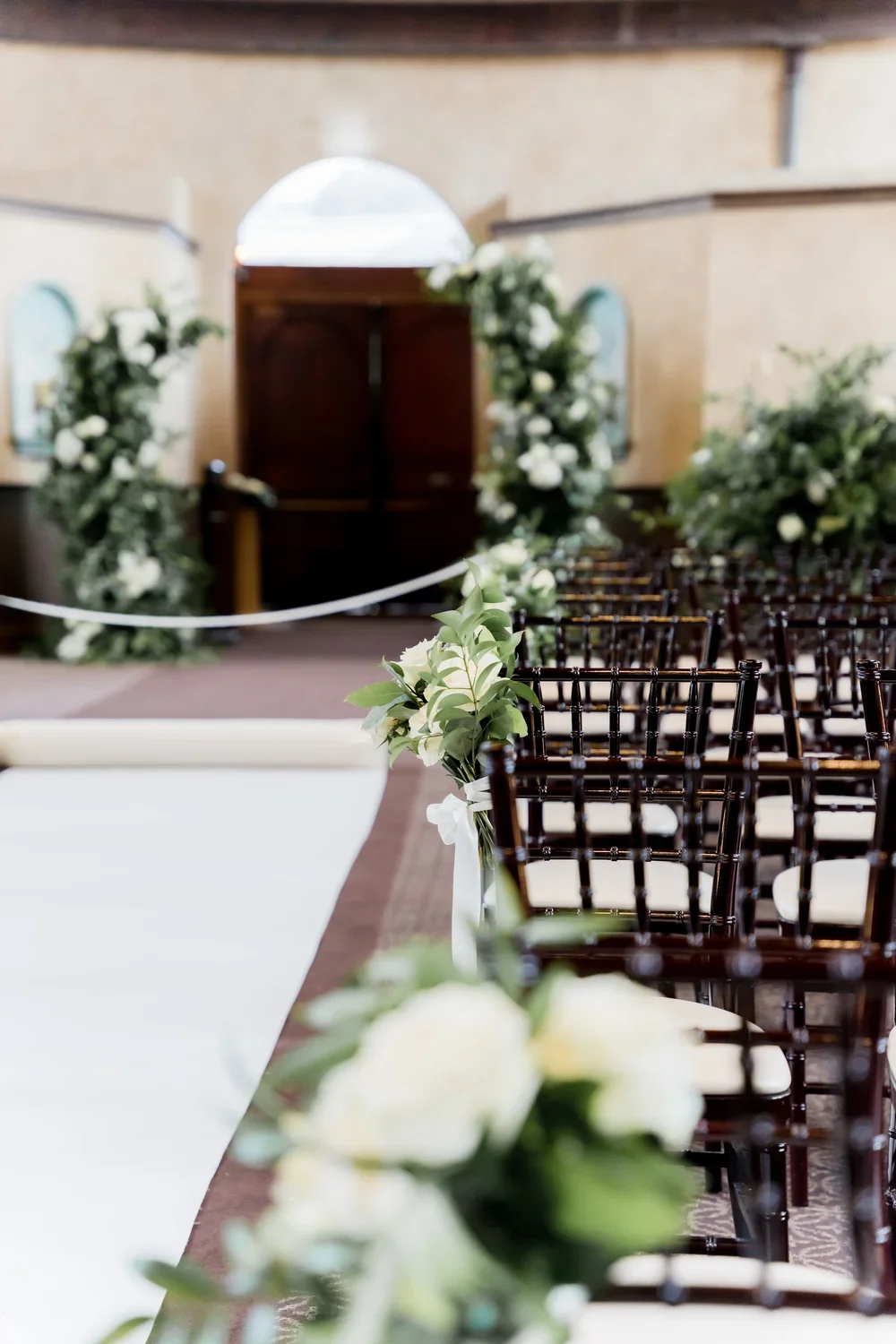 Ceremony Aisle with Green and White Floral Accents