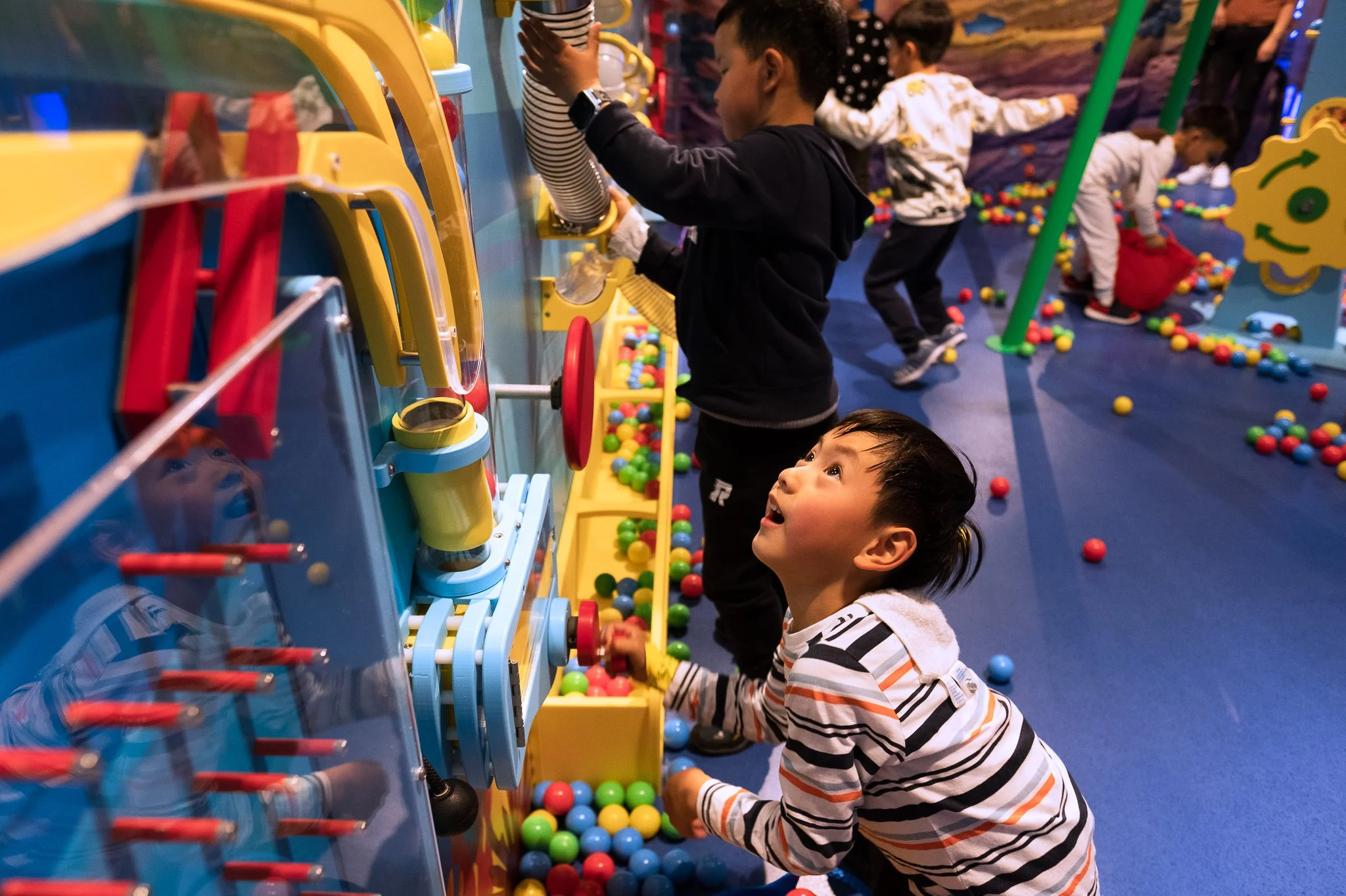 kid playing with piston ball lift
