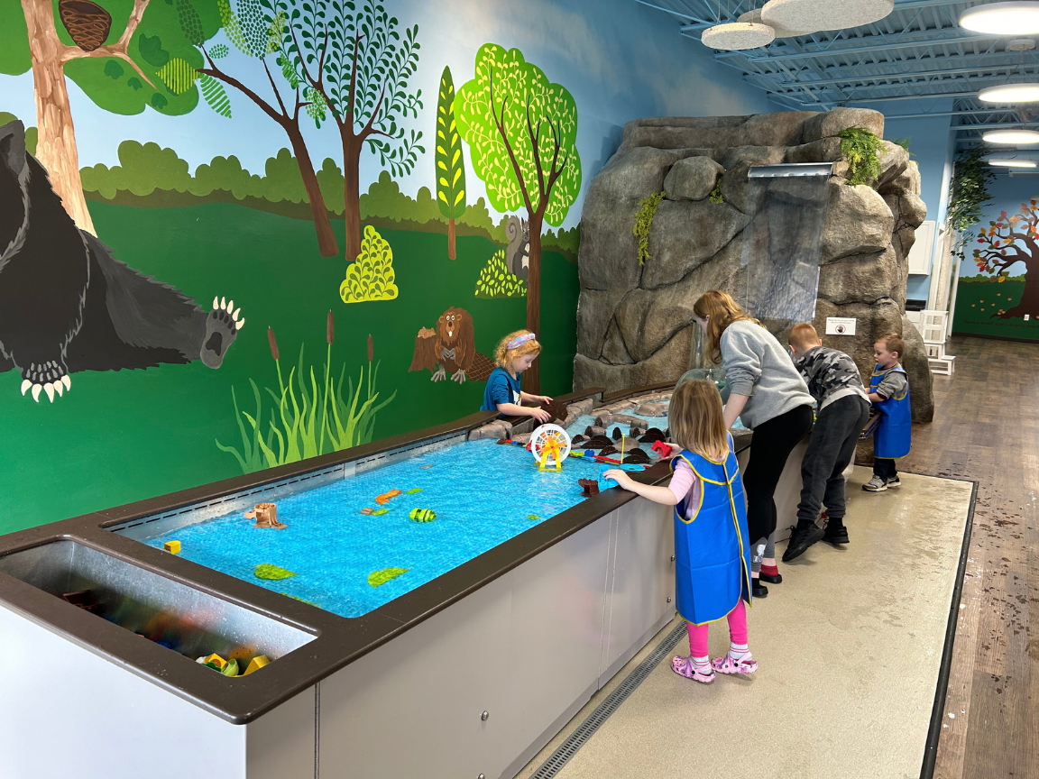 Children playing with an interactive water table