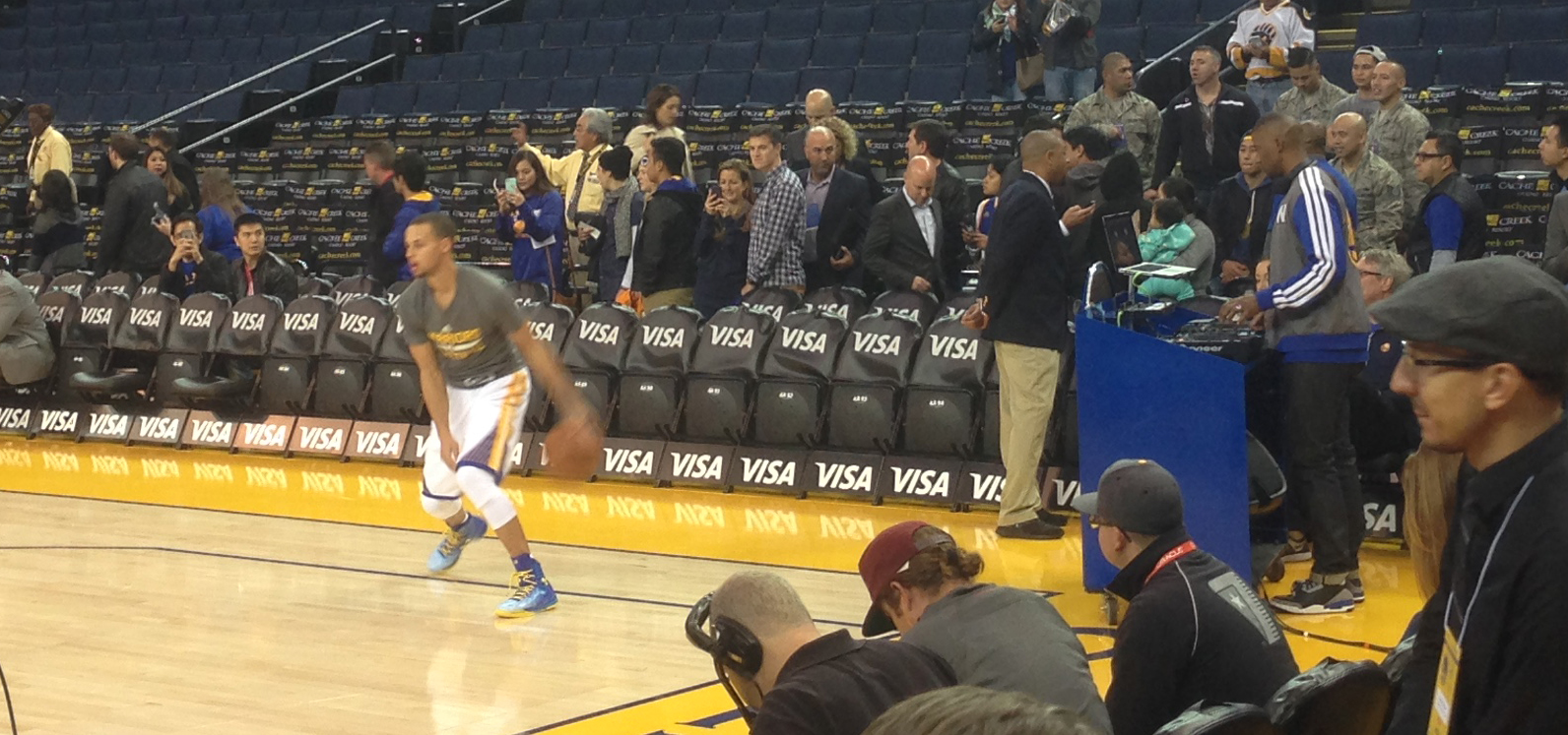 DJ D-Sharp (right) mixing for Warriors fans pre-game as Stephen Curry warms-up during shoot around.