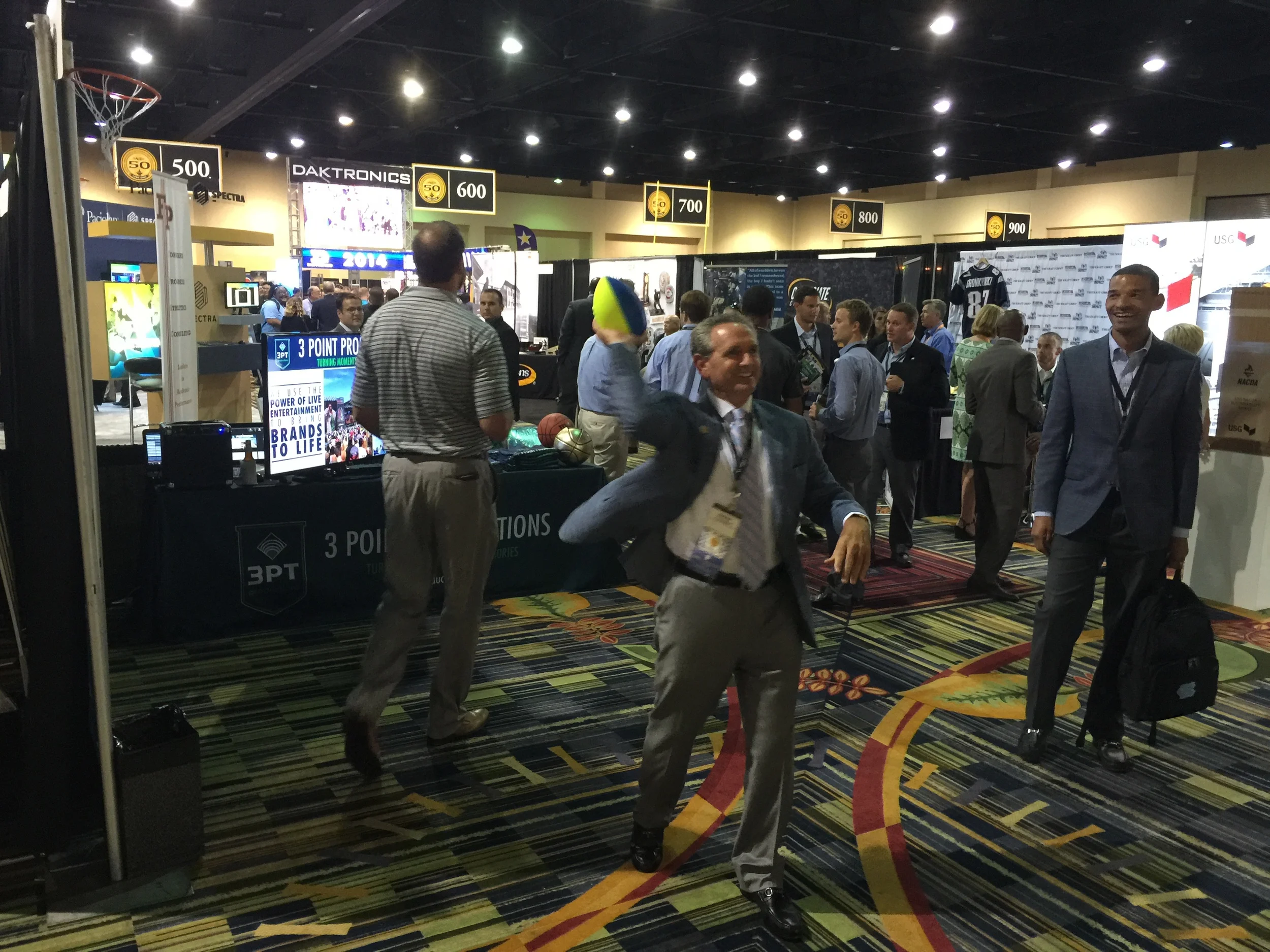 Even University of North Carolina AD, Bubba Cunningham, stopped by the booth to throw a few footballs.