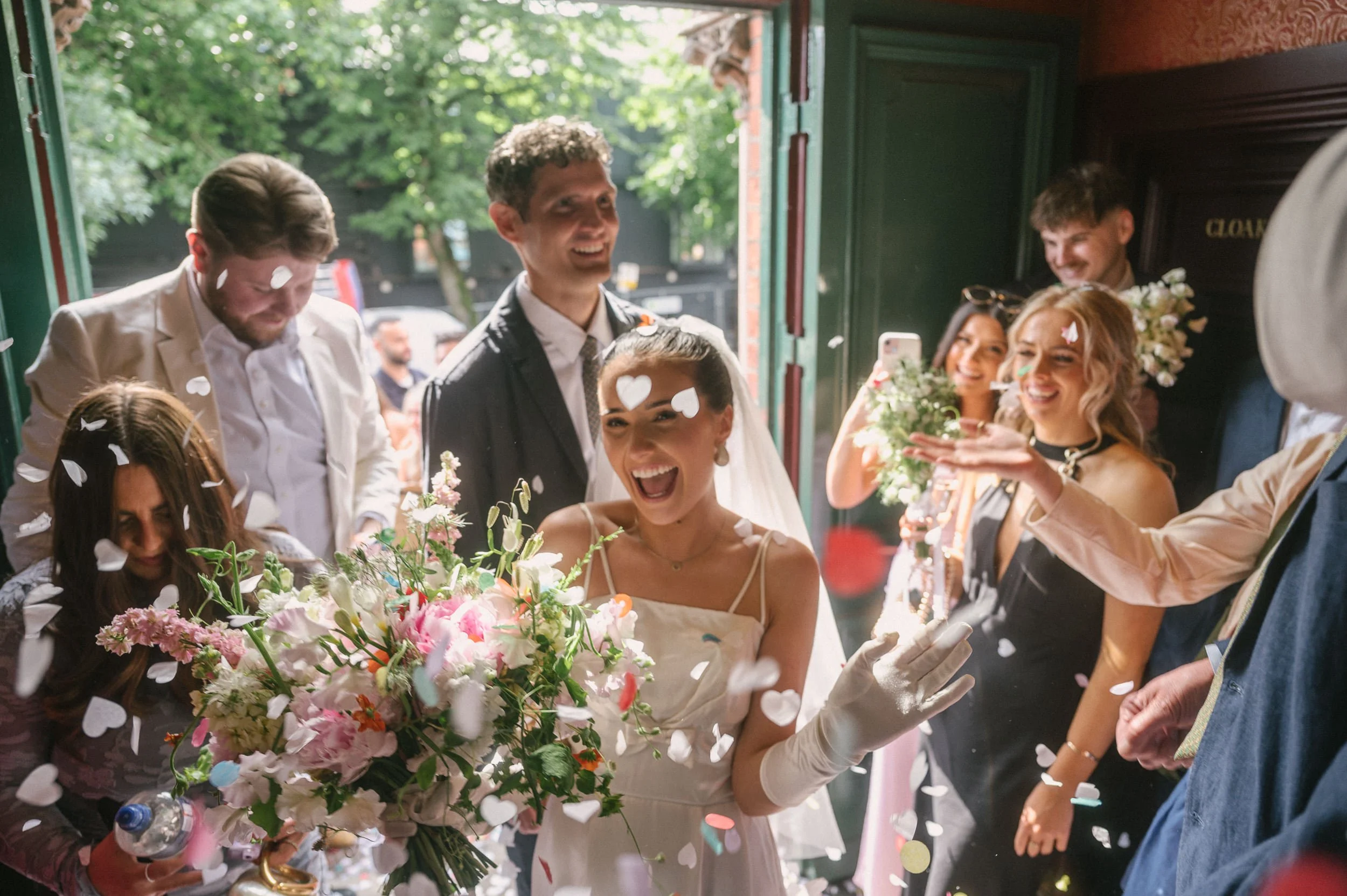bride arrives in confetti shower at Empire Music Hall Belfast wedding