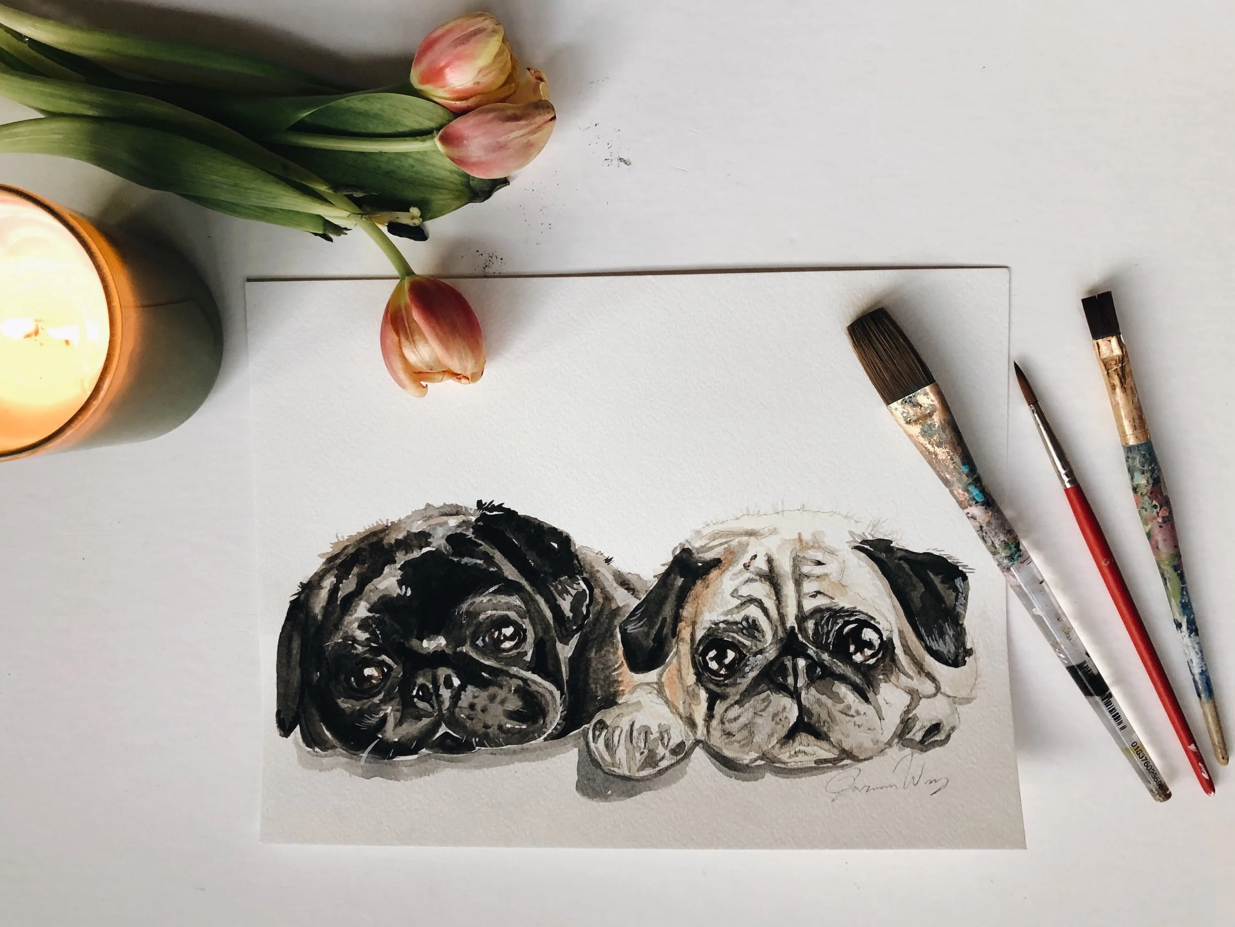 TWO PUGS IN A RUG