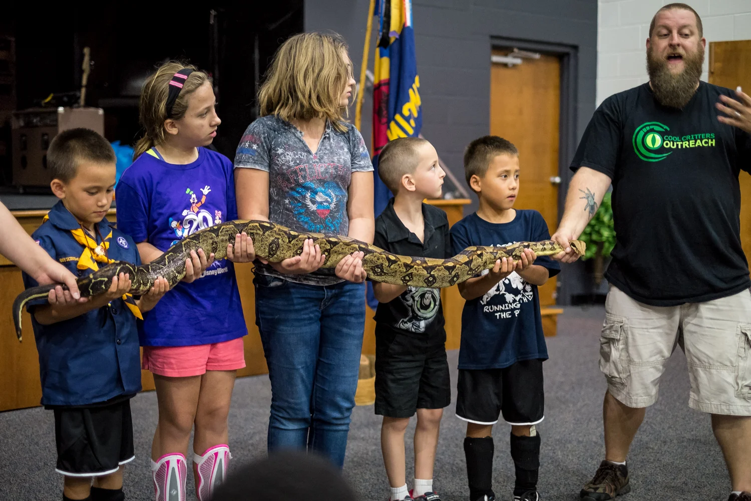 Brian Gill of Cool Critters Outreach has some volunteers help him show off a cool critter