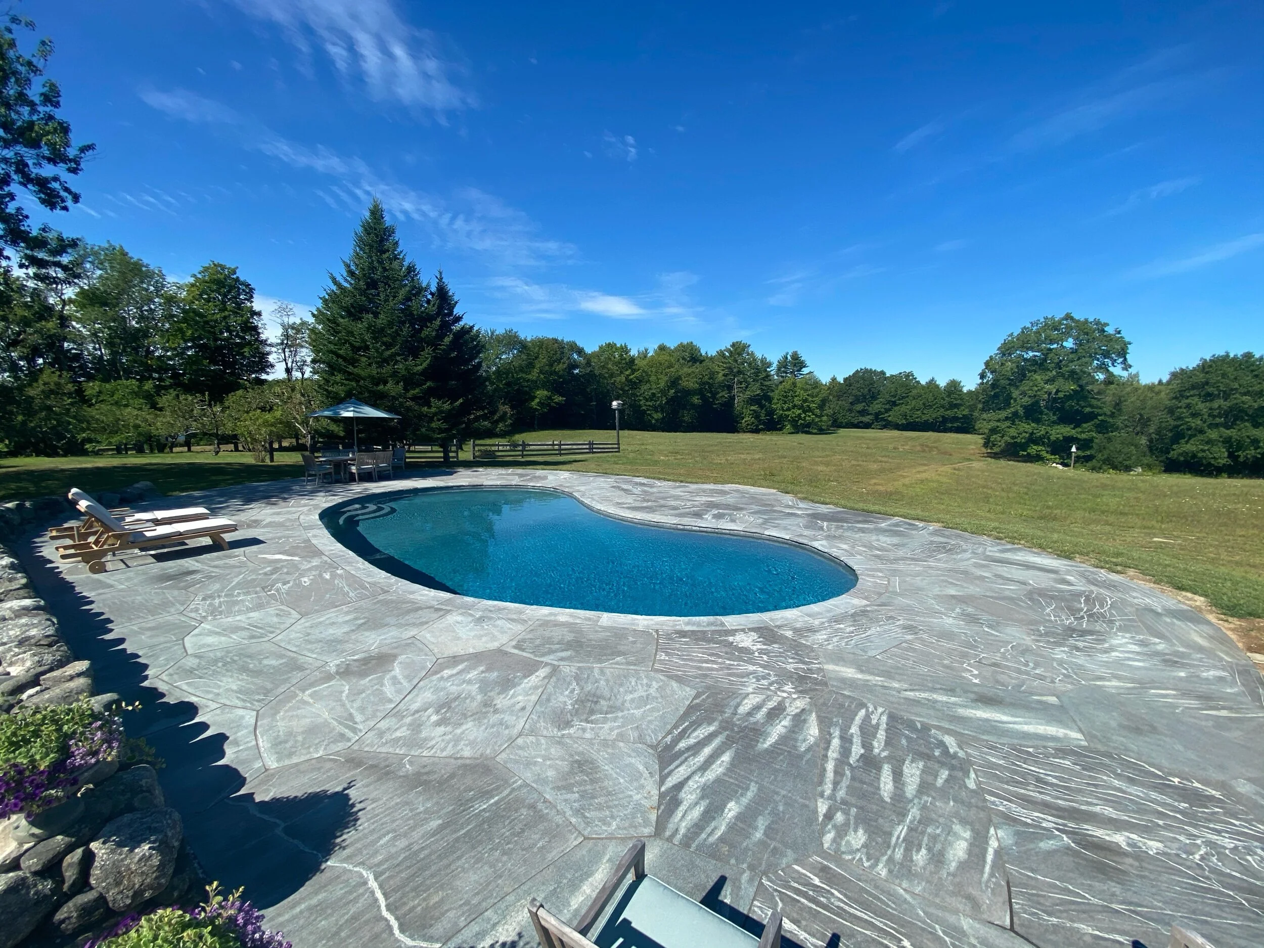 The Mystic Mountain pool patio was a renovation of an existing pool patio with a much smaller footprint. The side adjacent to the field will be left bare to enable swimmers to have an unobstructed views of the amazing views of the field.