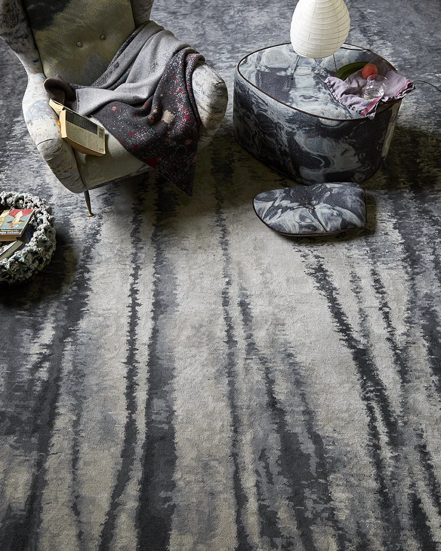 Echoes of Autumn The Echo Rug in "Charcoal" colorway for Perennials. The design is derived from a photograph I took of leaf stripped tree trunks, reflected in a rippling pond, in upstate New York