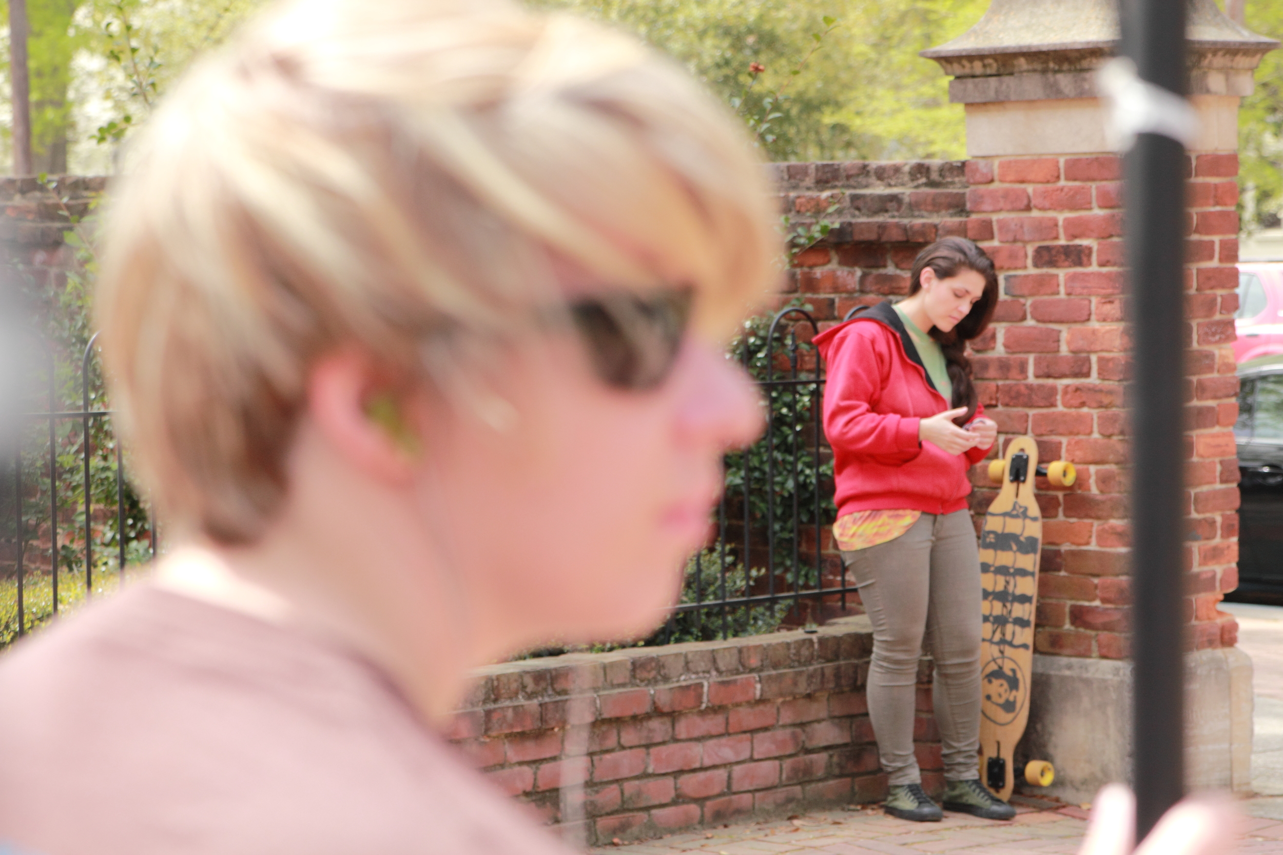  Sarah adjusts audio while Kate checks her phone. 