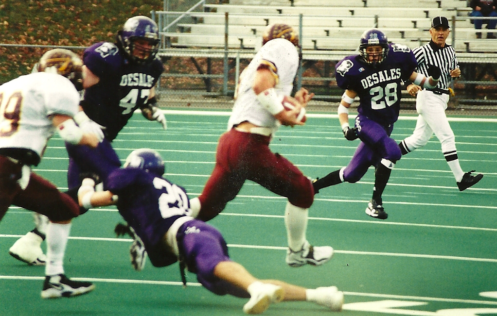 Grant Bowman (47) and Tom Marre (28) close in on a Walsh ball carrier