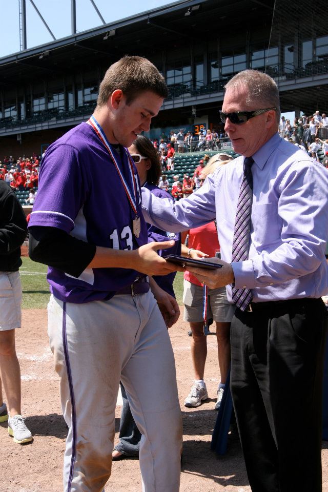 Senior Nick Eltzroth receives some hardware from Principal Dan Garrick