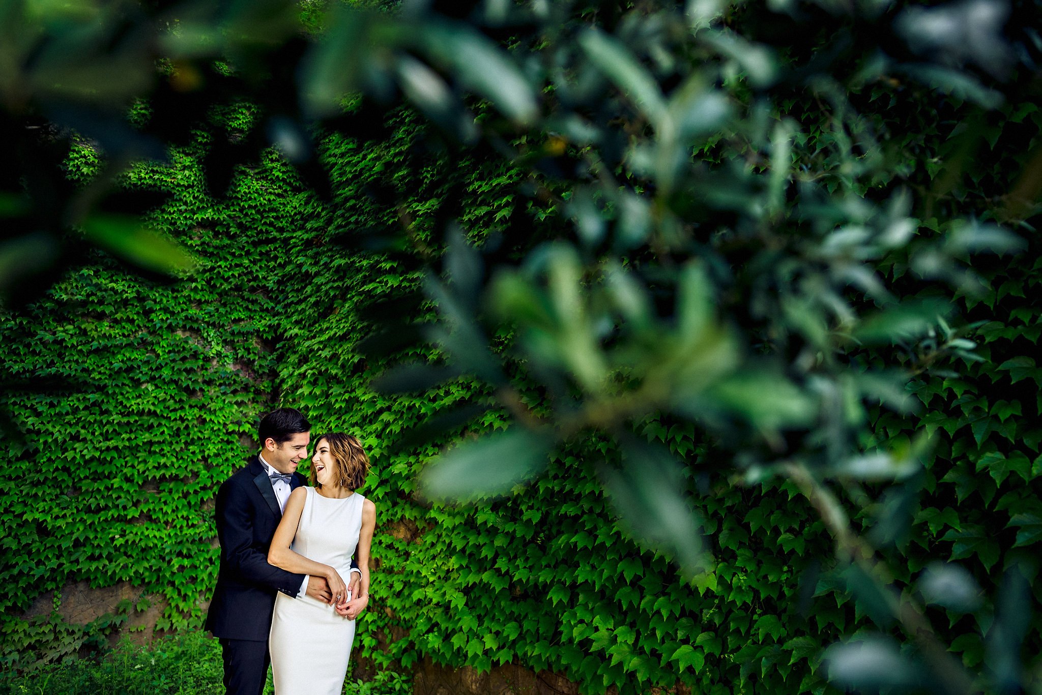 Portrait of bride and groom laughing under a tree in Sorrento, Italy