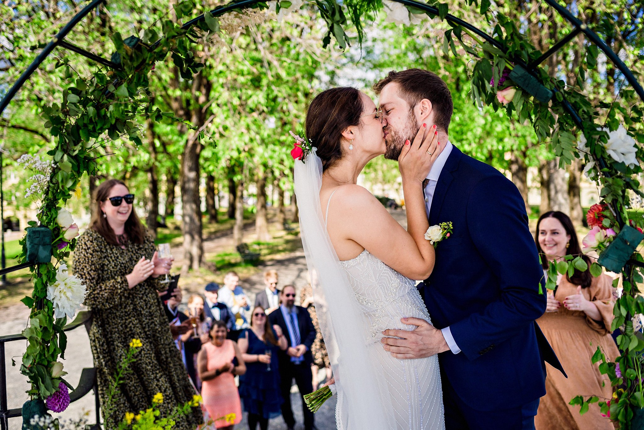 Bride and groom's first kiss in outdoor ceremony at Torshovparken in Oslo