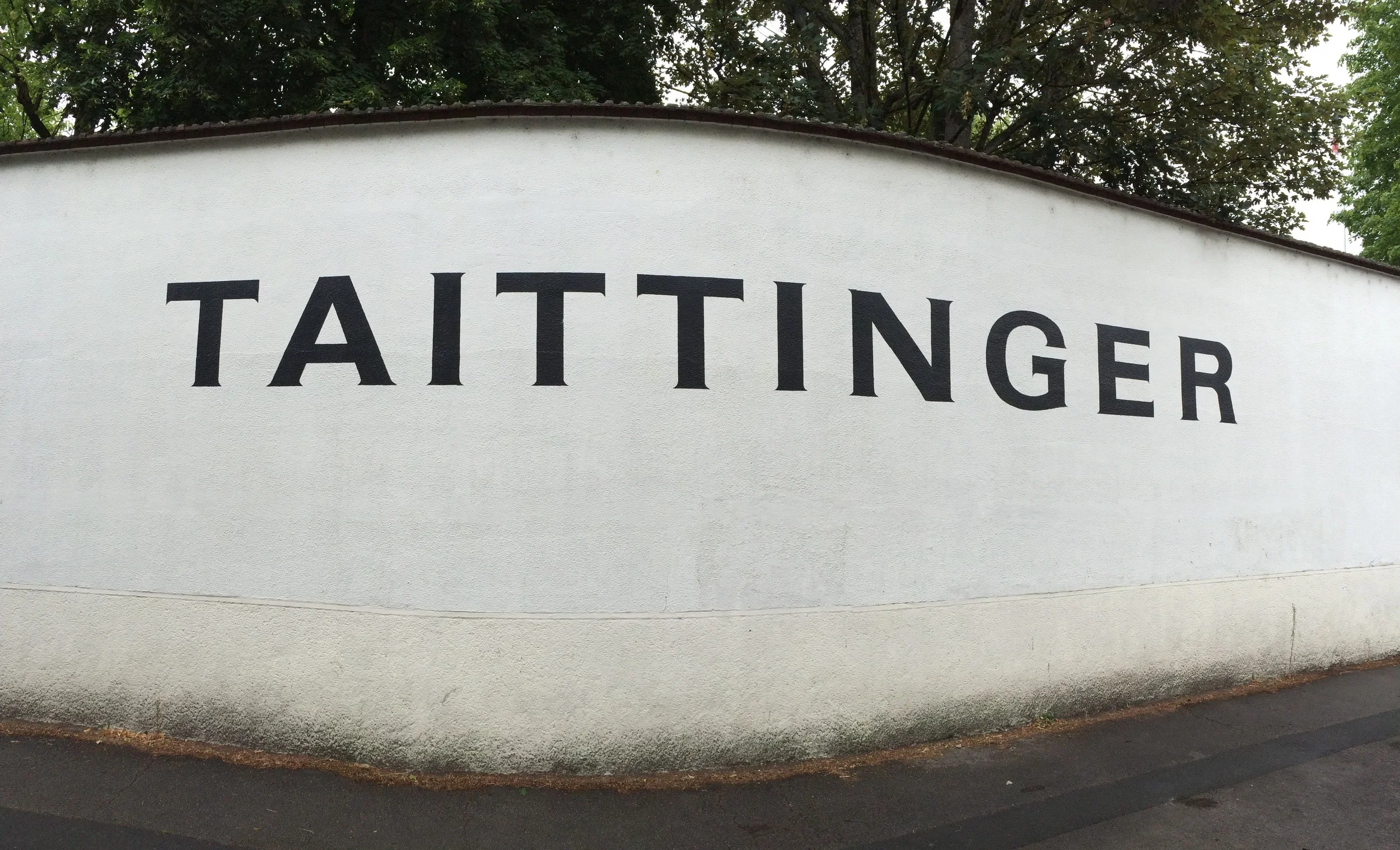 The wall leading up to the gates of Taittinger Champagne House. 