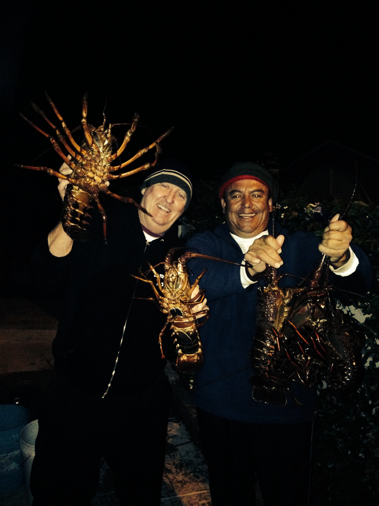 The boys with some spiny lobsters after a good charter in Avalon, Catalina Island
