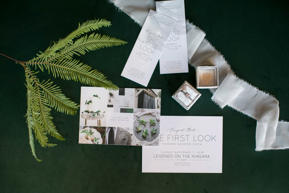 flatlay of first look autumn wedding show tickets and promotional materials