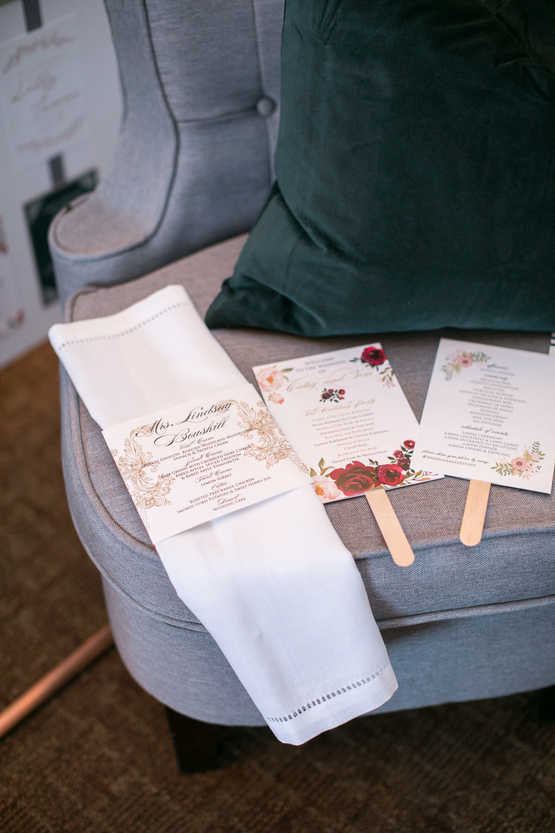 fltlay of wedding day stationary with linens and armchair