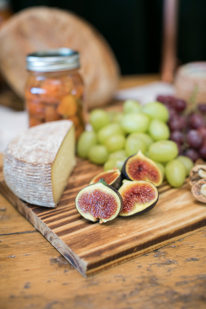 charcuterie board with brie, figs and grapes