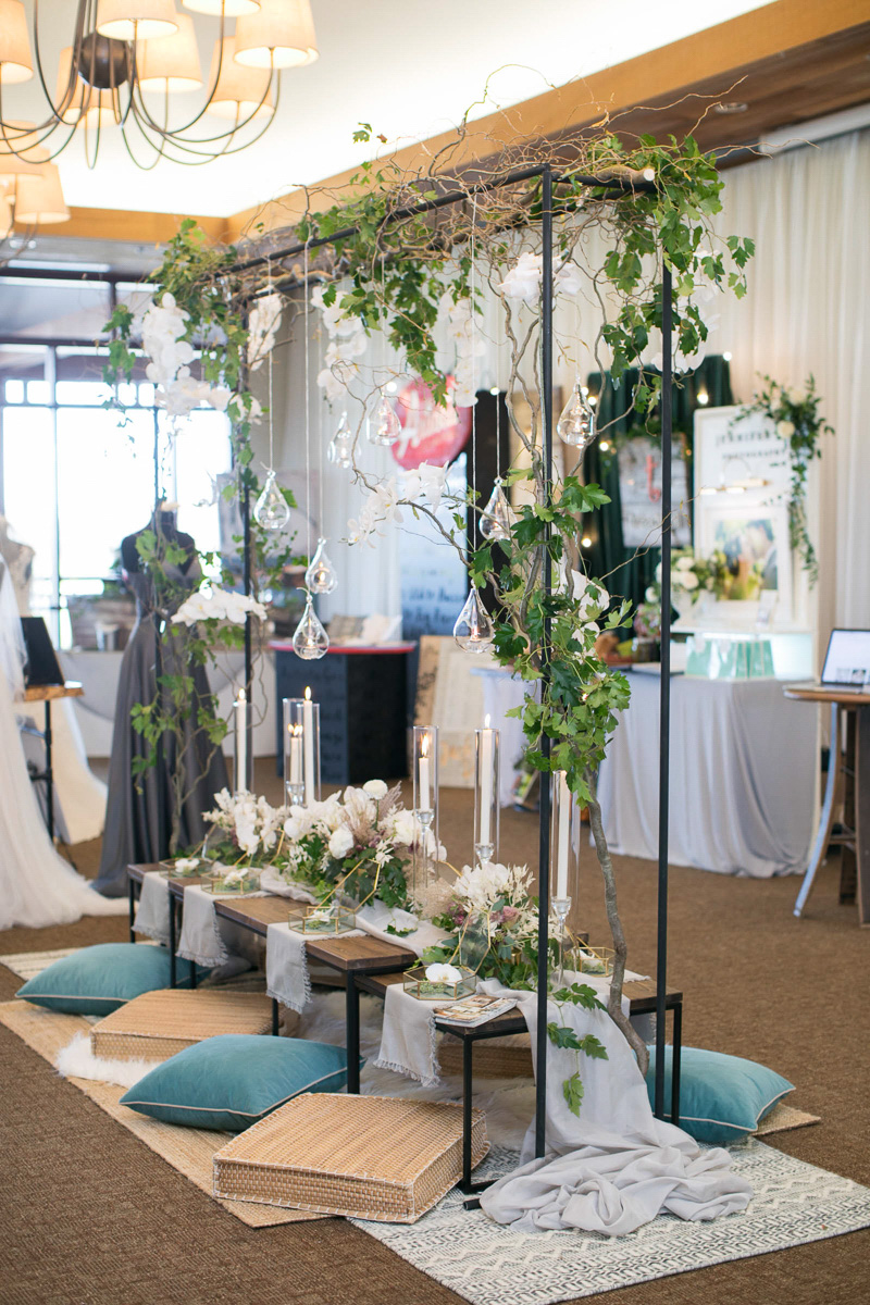 wedding day tablescape with metal and greenery structure