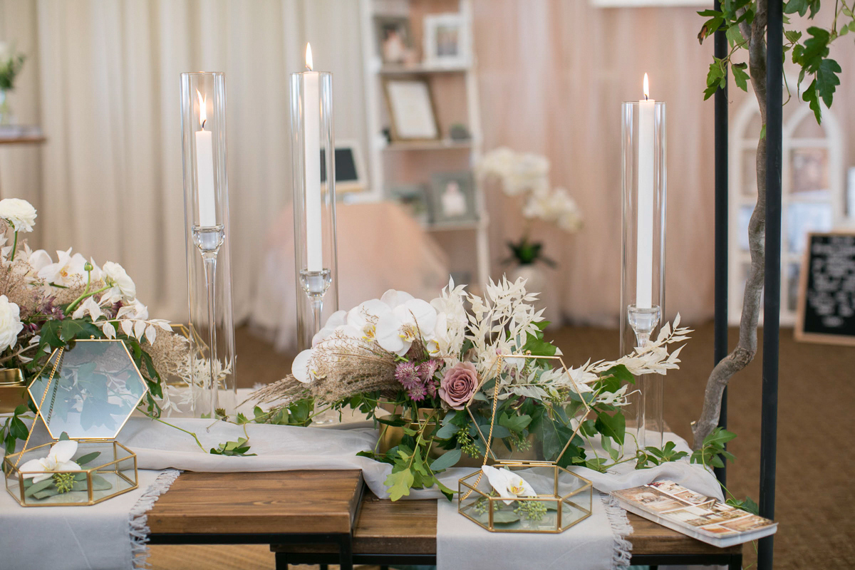 wedding tablescape and place settings with candles and florals