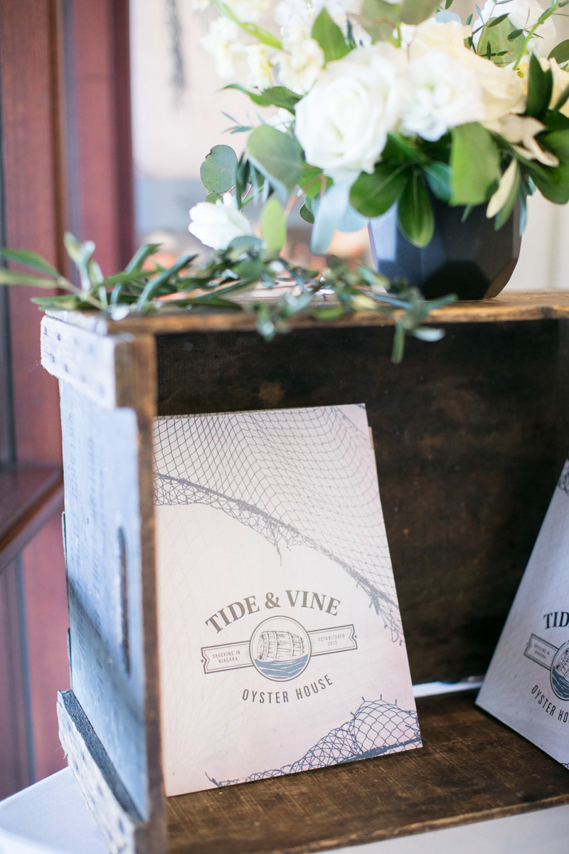 tide and vine menu with wooden crate and florals