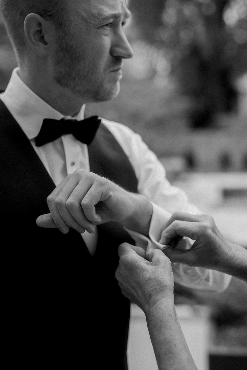  Groom adjusting his cufflinks. 