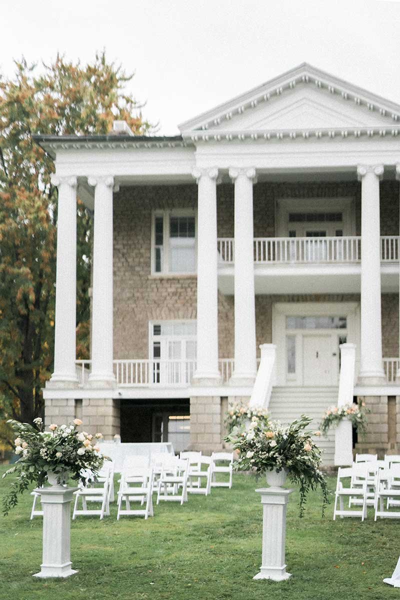  Historic estate wedding venue set up for an outdoor ceremony.  