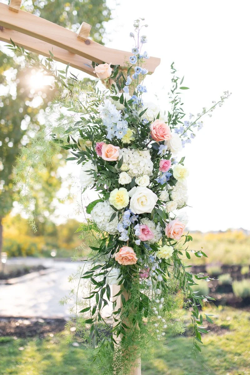 close view of the floral arbour at an outdoor ceremony site