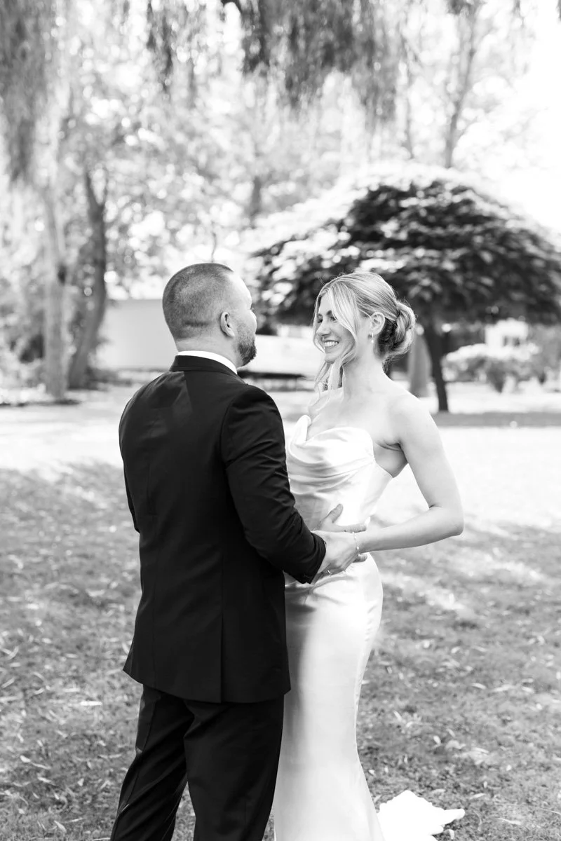 bride and groom smiling at each other during their first look