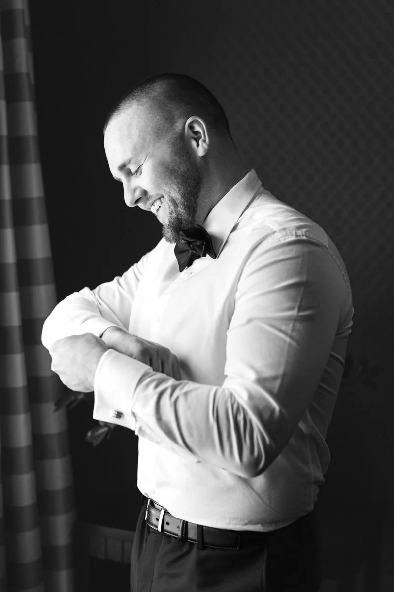groom getting dressed and adjusting cufflinks
