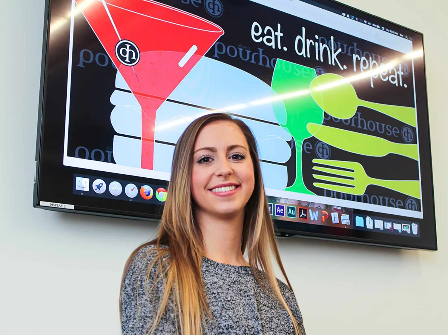 Breanna Kelly with her design which was chosen for Oliver's Pourhouse restaurant.