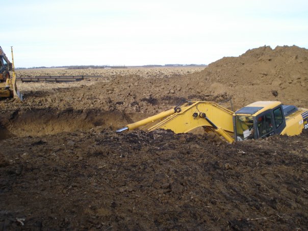 windmill backhoe in hole, barely visible.jpg