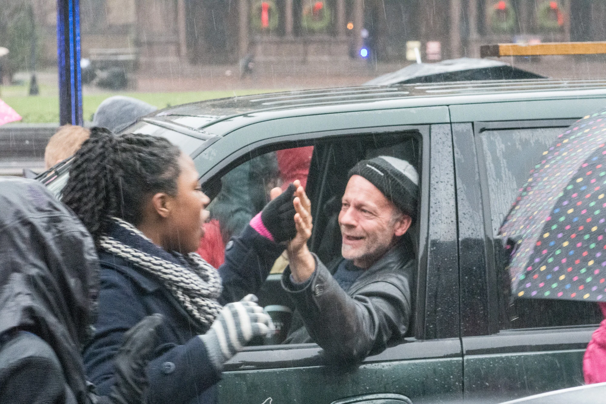 This guy was thrilled to be stuck in traffic. He enthusiastically high-fived as many of the students he could as they marched past.