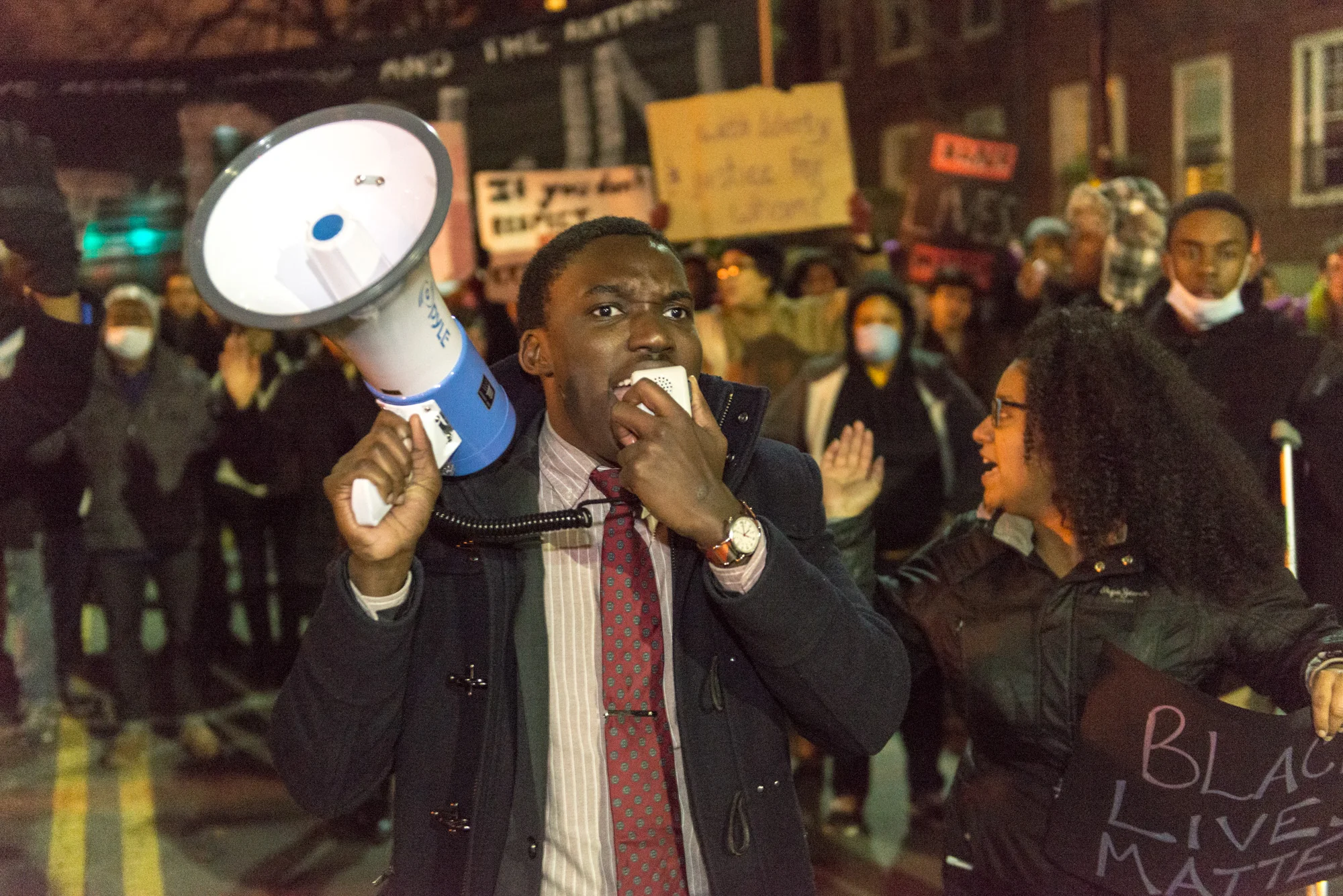 Another organizer leading the march yelling "No justice, no peace, no racist, police."