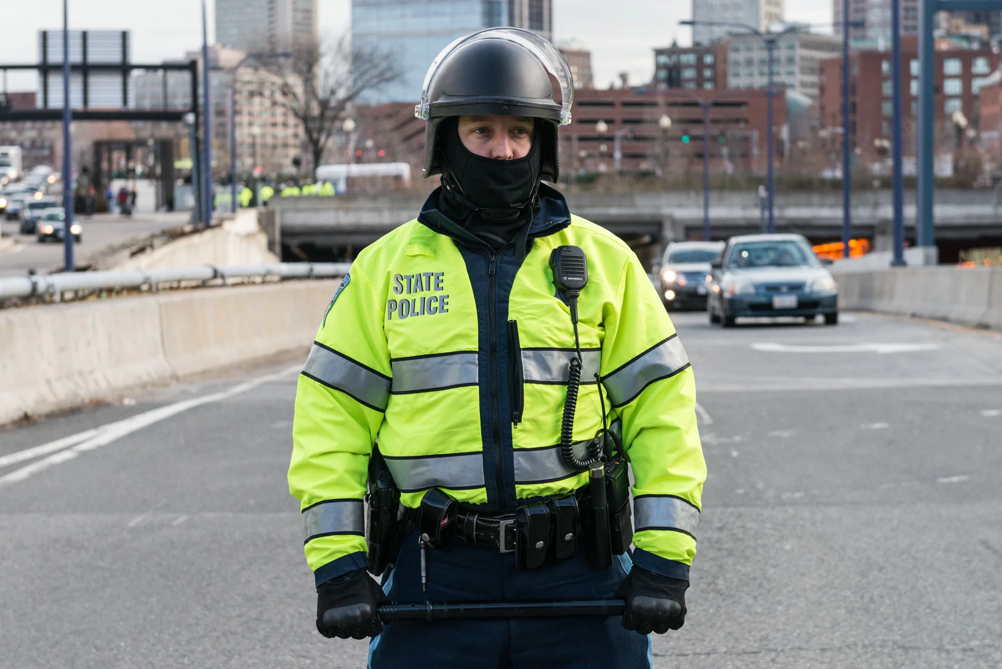 State Trooper with baton in hand blocking the roadway