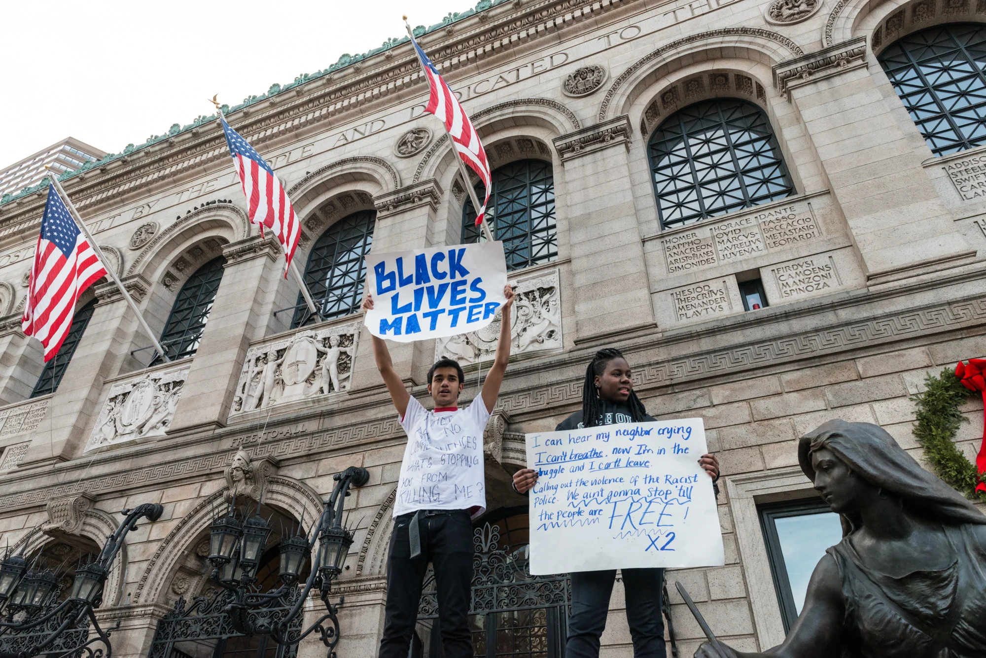 Standing on the statue platform in front of the Boston Public Library